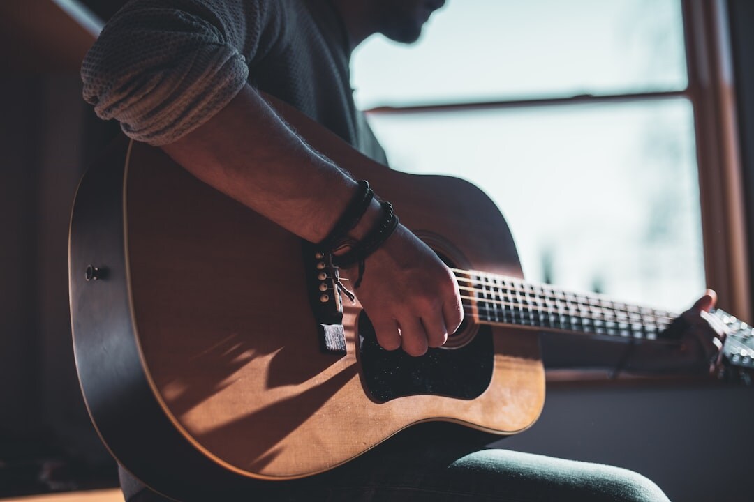 Uruguayan musician playing an acoustic guitar during a rehearsal